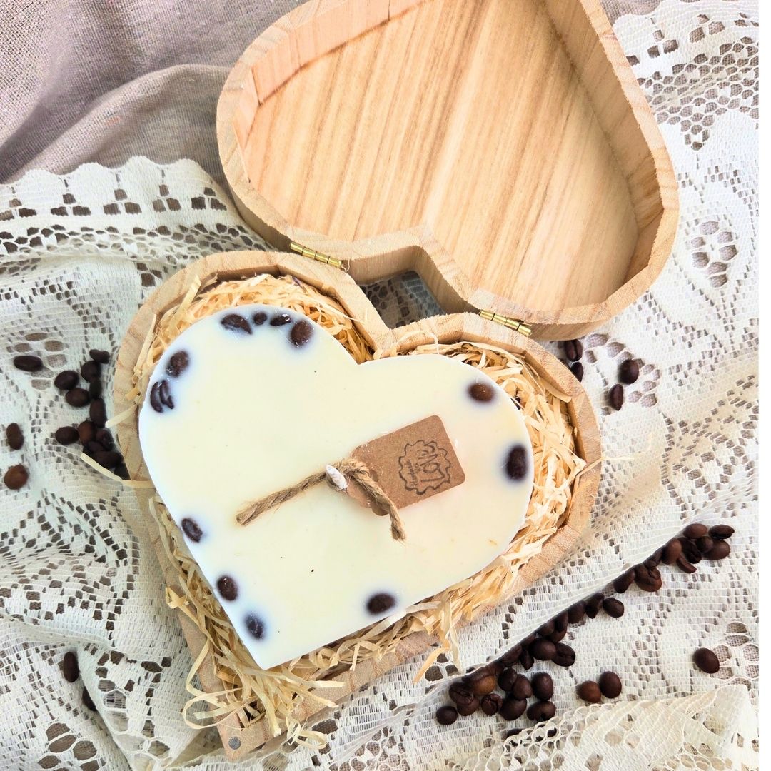 Top view of large heart candle in wooden box, featuring coffee bean decoration