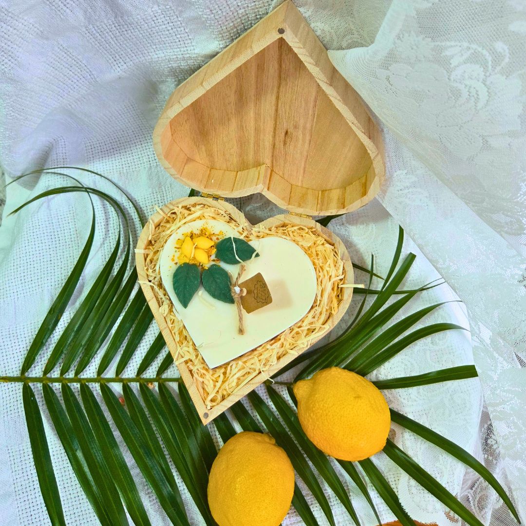 Detailed view of wooden heart box and lemon candle, perfect gift