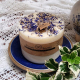 Large Wild Flowers soy candle 700g with blue cornflowers decoration on blue ceramic plate, styled with white lace doilies and fresh foliage - rustic lifestyle photography