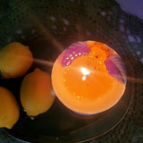 Medium lemon candle burning with natural botanicals showing clean wax pool - handmade soy wax candle quality