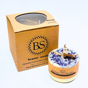 Small wild flowers scented soy candle decorated with blue cornflowers and natural botanicals in kraft gift box packaging