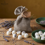 Burlap bag with wax melts and lavender flowers on a wooden surface, featuring Beauty Scents branding.